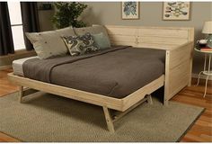 a bed sitting on top of a wooden frame