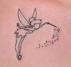 the back of a woman's stomach with a small tattoo of a fairy on it