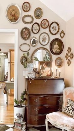 a living room filled with furniture and lots of plates on the wall