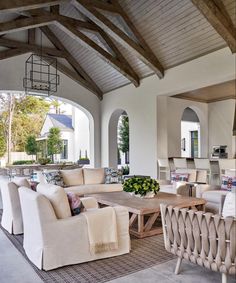 a living room filled with furniture next to an open kitchen and dining room area on instagram