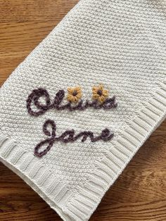 an embroidered dish cloth with the words olive jane on it