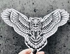 an owl sticker is shown in the shape of a hand holding up it's wings