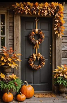 a front door decorated for fall with wreaths and pumpkins