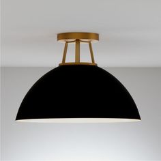 a black and gold light hanging from the ceiling