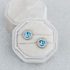 Beautiful topaz earrings with unique design. You can wear these earrings 2 ways: gold studs only or compliment them with stones halo. - 14k gold (color can be chosen) - Natural swiss blue topazes and Swarovski Zirconia - Size: 5.5 mm stud and 9.7 mm with stones halo Free gift box. Express shipping with DHL (3-6 business days). If you want to replace emeralds with other stones please write us, and we'll calculate the cost with the gems you want. See more at our shop https://www.etsy.com/shop/Jewe Stone Earrings Gold, Gold Studs Earrings, Blue Stone Earrings, Gold Topaz, Studs Earrings, Topaz Earrings, Swiss Blue Topaz, Gold Earrings Studs, Gold Studs