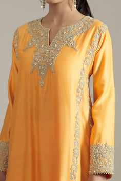 Mango chanderi silk kurta with dori embroidered floral motifs highlighted by cutdana. Comes with farsi pyjama and dupatta. Components: 3 Pattern: Embroidered Type Of Work: Sequin,Cutdana Neckline: Notched Sleeve Type: Three quarter Fabric: Chanderi Silk,Net Color: Yellow Other Details:  Kiran lined dupatta Attached lining Closure: Pant: Elasticated waistband Occasion: Mehendi and Haldi,Sangeet - Aza Fashions Anarkali Kurta With Intricate Embroidery In Raw Silk, Gold Chanderi Palazzo Set With Intricate Embroidery, Anarkali Raw Silk Palazzo Set With Intricate Embroidery, Designer Raw Silk Palazzo Set With Intricate Embroidery, Festive Raw Silk Palazzo Set With Intricate Embroidery, Embroidered Cotton Silk Palazzo Set For Eid, Festive Palazzo Set With Intricate Embroidery In Raw Silk, Unstitched Raw Silk Palazzo Set With Intricate Embroidery, Designer Raw Silk Palazzo Set With Resham Embroidery