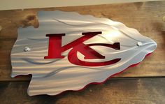 a metal kansas state sign on a wooden table