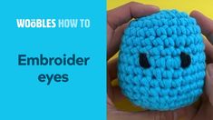 someone is holding up a crocheted blue object with the words woobles how to embroider eyes