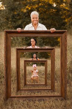 an older woman holding up a wooden frame with two children in it and the image is being taken from behind