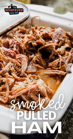 shredded pulled ham in a white casserole dish with text overlay that reads smoked pulled ham