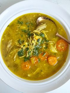 a white bowl filled with soup and vegetables