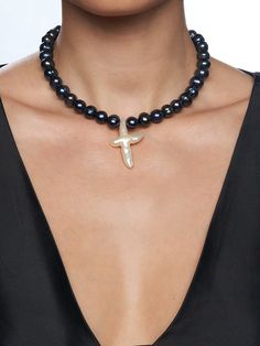 Large Black Freshwater Pearls Freshwater Pearl Cross Pendant Stainless Steel Clasp Length: 15 or 18 Inches + Extension Chain 15 Inch Size Pictured Handmade in Los Angeles - please allow 1-5 business days for this item to ship THE BLACK PEARL GEMMA CROSS CHOKER features stunning iridescent black pearls, punctuated with a large white freshwater pearl cross pendant. This one-of-a-kind piece will elevate all your looks. Wear it to update a simple tee look or to complete a night fit! The Black Pearl, Iridescent Black, Black Freshwater Pearls, Cross Choker, Black Pearls, Simple Tees, White Freshwater Pearl, Black Pearl, Large White