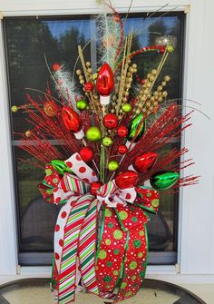 a decorated christmas wreath on the front door