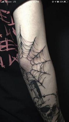 a person with a spider web tattoo on their arm