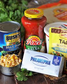 some food is sitting on a table next to other foods and condiments in tins