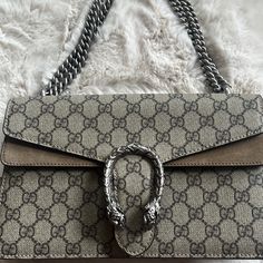 - Gucci Dionysus Gg Small Shoulder Bag In Canvas And Suede (Nwt) - Bag Is New; In Pristine Condition - A Structured Gg Supreme Canvas Bag With Our Textured Tiger Head Closure-A Unique Detail Referencing The Greek God Dionysus, With Suede Trim - The Sliding Chain Strap Can Be Worn Multiple Ways, Changing Between A Shoulder (15" Drop) And A Top Handle Bag (8.7" Drop) - Beige/Ebony Gg Supreme Canvas, With Taupe Suede Detail - Accordion Style - Antique Silver-Toned Hardware - Pin Closure With Side R Gucci Beige Bags With Silver-tone Hardware, Gucci Brown Shoulder Bag With Silver-tone Hardware, Gucci Brown Bag With Silver-tone Hardware, Brown Gucci Bag With Silver-tone Hardware, Brown Gucci Bags With Palladium Hardware, Designer Gucci Clutch Shoulder Bag, Luxury Gucci Clutch Bag, Designer Gucci Clutch Bag, God Dionysus