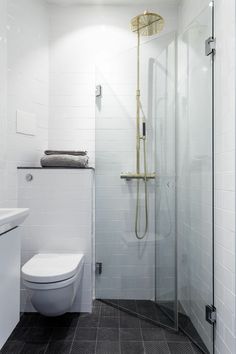 a white toilet sitting next to a walk in shower