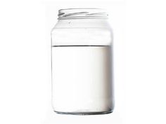 a glass jar filled with white liquid