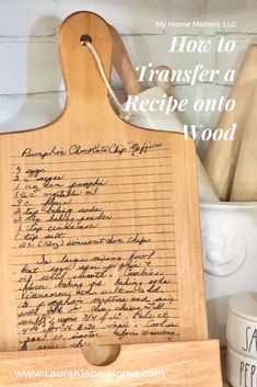 a wooden cutting board with writing on it next to kitchen utensils and other items