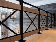 a room with wooden floors and metal railings on the walls, along with wood flooring