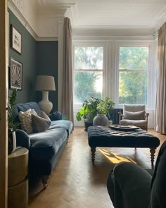 a living room filled with furniture and windows