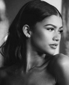 a black and white photo of a woman with her hair in a pony tail style ponytail