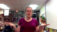 a woman standing in front of a whiteboard with her hands out to the side