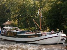 a white boat floating on top of a river