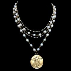 The Sophia Freshwater Pearl Saint Michael necklace features the Saint Michael Victory Medallion. Saint Michael is known and respected in many of the World Religions including Judaism, Christianity and Islam. He protects us from evil and many miracles have been attributed to him over the ages. He is leads the Angelic realm and is often depicted slaying the dragon who symbolizes evil. Michael is the patron saint of police officers, soldiers and doctors. By invoking his help he has been known to mi Bohemian Pearl Necklace, Top Jewelry Trends, St Michael Necklace, Susan Shaw, Layer Necklaces, Medical Jewelry, Angelic Realm, Angel Necklace, Saint Michael