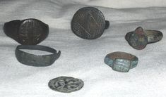 an assortment of ancient roman coins and rings