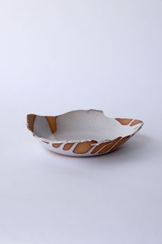 an orange and white bowl sitting on top of a table