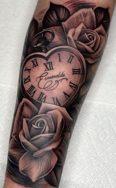 a tattoo with roses and a clock on it