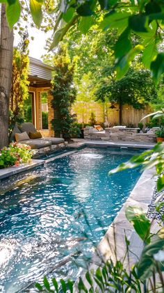 an outdoor swimming pool surrounded by greenery