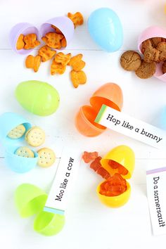 an assortment of plastic toys including eggs, cookies and candies on a white surface