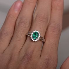 This is a gorgeous handmade creation. Its beauty is its simplicity & Elegance. The 6*8mm lab emerald is crafted in solid sterling silver and with rhodium plated. It's made to order and it will take about 7-10 days to make it. All item is sent in a beautiful gift box You can realize more lovely stuff clicking the link https://www.etsy.com/shop/knightjewelry?refshopsection_shophome_leftnav Please leave the correct address and you phone number for delivering successfully. Oval Emerald Ring In 14k White Gold, Oval Tsavorite White Gold Ring, Oval Tsavorite Ring In White Gold, Sterling Silver Emerald-cut Ring With Center Stone, Formal Sterling Silver Emerald Ring With Brilliant Cut, Elegant Tsavorite Birthstone Ring, Silver Emerald Solitaire Ring In 14k White Gold, Sterling Silver Emerald Ring With Halo For Promise, Timeless Emerald Ring With Halo Design