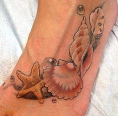 a foot tattoo with seashells and starfish on it