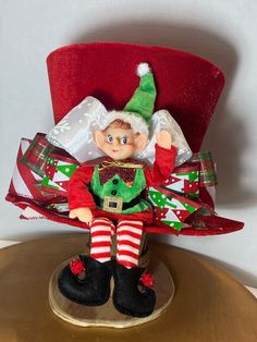 an elf doll sitting on top of a red chair