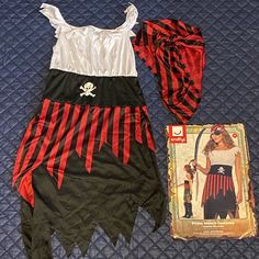 a pirate costume and book laying on a bed