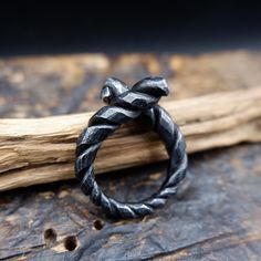 Black, twisted iron ring perfect gift for a man, boyfriend or husband. Made using traditional blacksmithing techniques of fire, hammer and anvil.  Surface texture is achieved through different shaped hammers and hand held chisels and profiling tools. The ring sealed with a clear wax for protection. US size- 10 1/2 Width - up to 7mm This original handiwork can become a exclusive, nice piece of your style. Presented in a gift bag.  European & International orders are sent by Standard post with tra Rustic Hand Forged Promise Ring, Artisan Hand Forged Black Jewelry, Hand Forged Black Rings For Anniversary, Artisan Black Hand Cast Jewelry, Artisan Hand Cast Black Jewelry, Artisan Black Hand-cast Jewelry, Hand Forged Spiral Ring, Black Oxidized Promise Ring, Hand Forged Spiral Ring As Gift