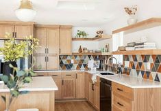 a kitchen with wooden cabinets and tiled backsplash