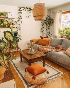 a living room filled with furniture and plants