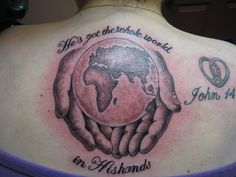 a woman with a tattoo on her back holding the world in her hands