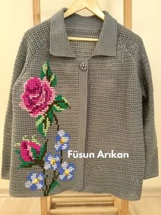 a knitted jacket with flowers on it