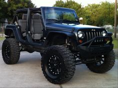 a black jeep parked on top of a driveway