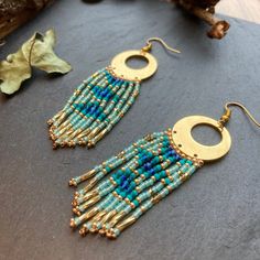 two pairs of gold and blue beaded earrings