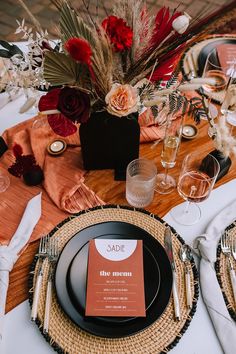 the table is set with place settings, silverware and napkins for an elegant dinner