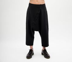 Update your streetwear with the Harem pants women. These Foll Loose fitting pants women feature a low waisted construction, front asymmetric button closure. The pants have two side pockets for convenient storage. This Navy pants for women is designed to flatter every body type and fit numerous occasions. When we designed thes harem pants we focus on the versatility of each model to make it a perfect match for your favorite accessories and wardrobe pieces. Perfect for slaying in the streets, pair Spring Baggy Drop Crotch Harem Pants, High Waist Harem Pants For Streetwear, Summer Fitted Bottoms With Drop Crotch, Relaxed Fit High-waisted Harem Pants For Streetwear, Fitted Casual Harem Pants With Drop Crotch, Luxury Black Harem Pants With Pockets, Baggy High-waisted Harem Pants For Streetwear, Relaxed Fit Drop Crotch Bottoms For Streetwear, Baggy Ankle-length Harem Pants For Streetwear