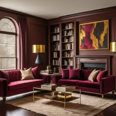 a living room with red couches and bookshelves