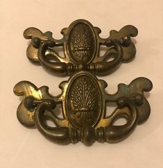 two antique brass door handles on white background