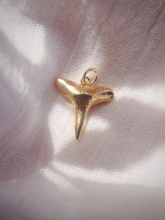 Add to your collection with this Genuine Shark Tooth Charm completely plated in gold. Choose from a regular jump loop or lobster clasp to make it your own and attach to any existing jewelry. Planning on purchasing a chain for this and need help attaching it? Let us know and leave a note during checkout! This item will arrive separate/detached if no note is left.✦ DETAILS ✦✧ Gold plated Genuine Shark Tooth.✧ 14kt Gold Filled Loop or Clasp.✧ Chains sold separately.✧ All Ke Aloha Jewelry pieces com Yellow Gold-plated Charms With Lobster Clasp, Gold Charms With Lobster Clasp For Jewelry Making, Gold Minimalist Dangle Charms, Gold Minimalist Pendant Charms, Minimalist Gold Pendant Charms, Yellow Gold Metal Charms For Gifts, Yellow Gold Metal Charms For Gift, Gold-filled Pendant Charms, Gold Pendant Charms In 14k Gold